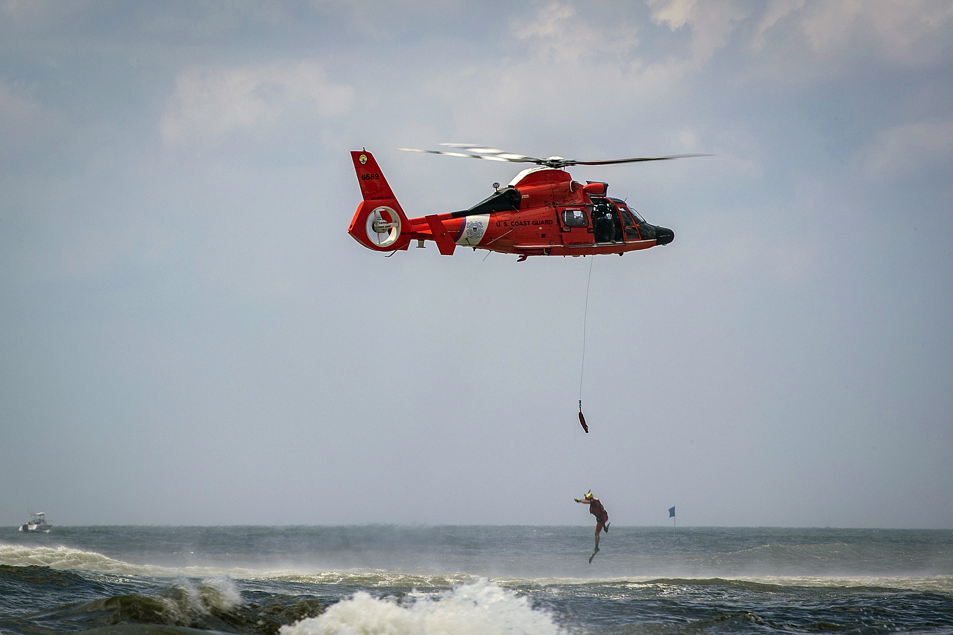 Coastguard Rescue swimmer jumps from helicopter